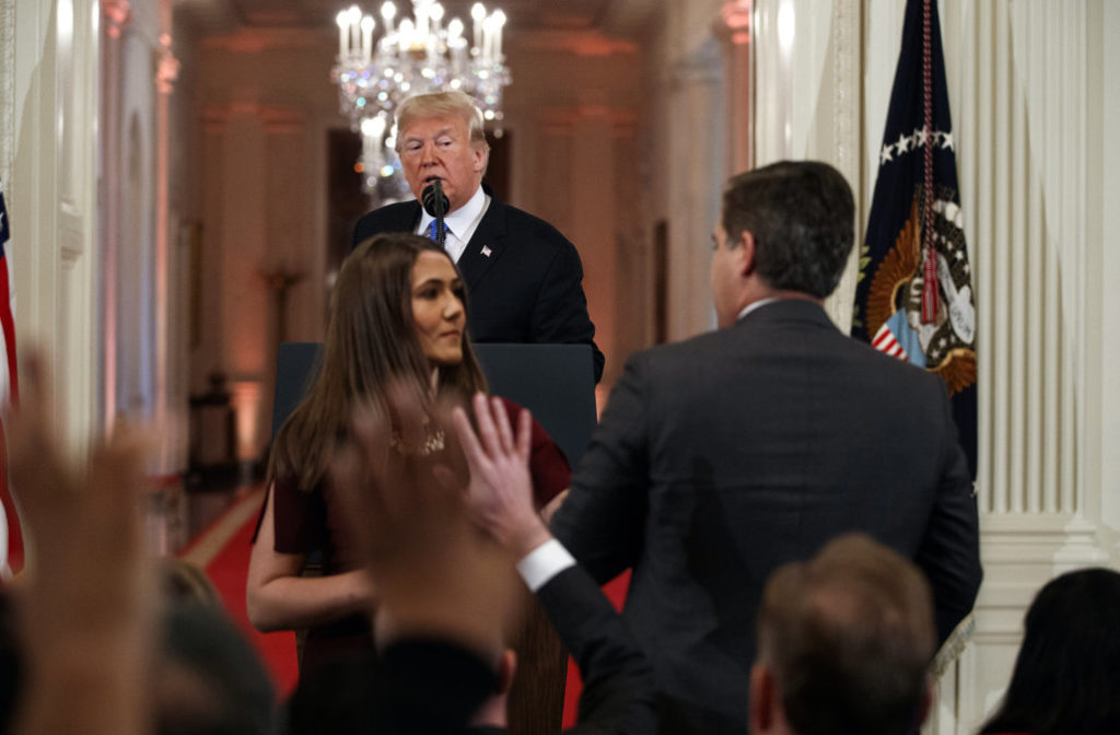 President Donald Trump watches as a White House aide takes away a microphone from CNN journalist Jim Acosta during a news conference in the East Room of the White House, Wednesday, Nov. 7, 2018, in Washington. (AP Photo/Evan Vucci)